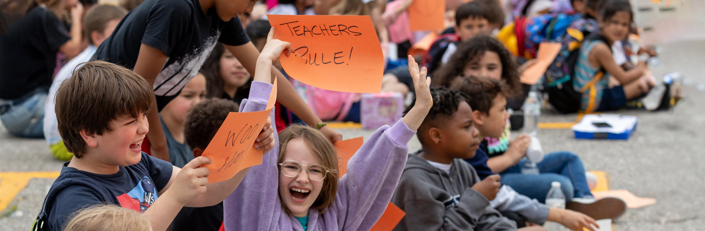 students cheering on teachers 